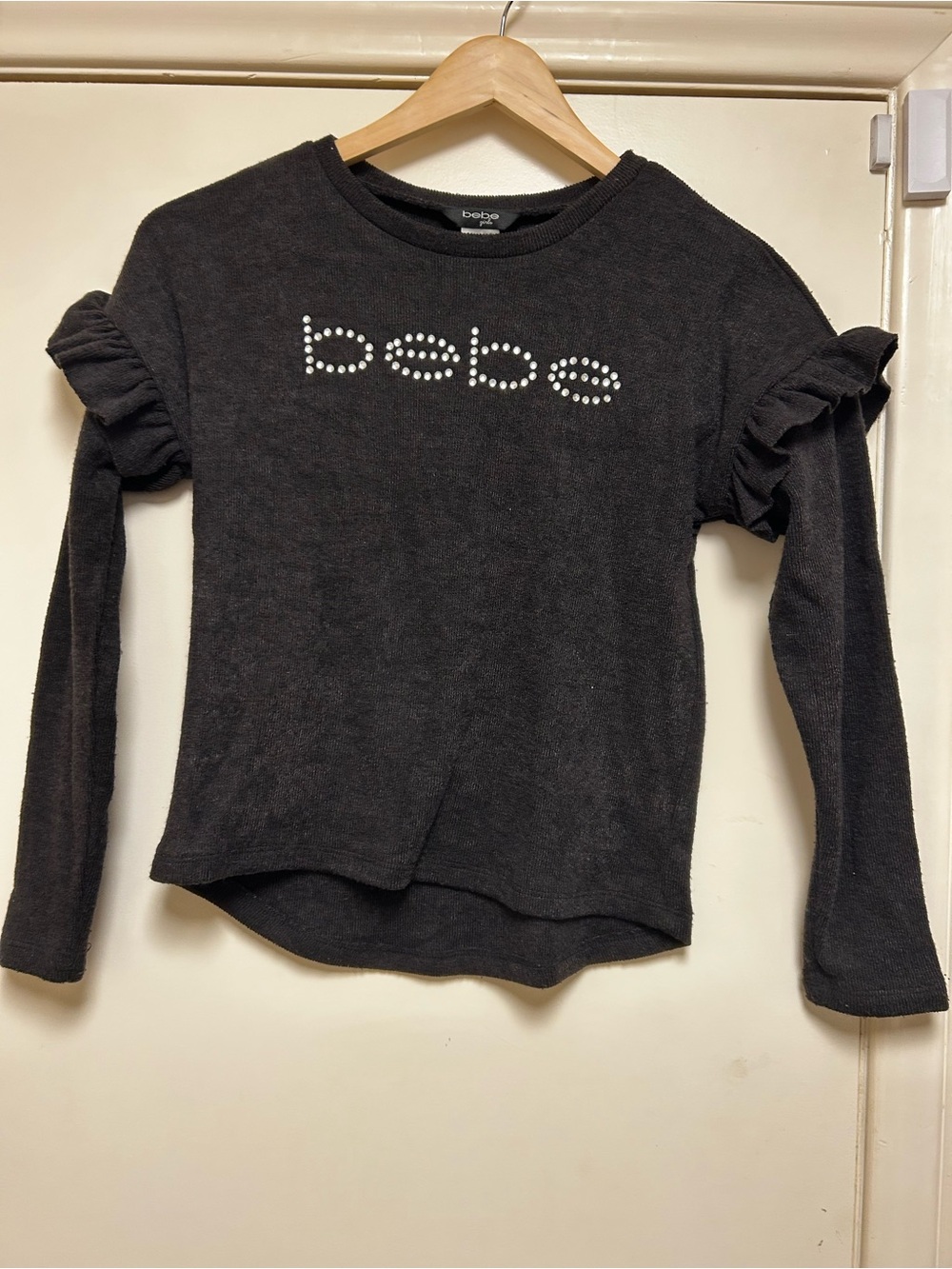 bebe Black Long Sleeve Ruffle Shoulder Tee with Crystal Logo